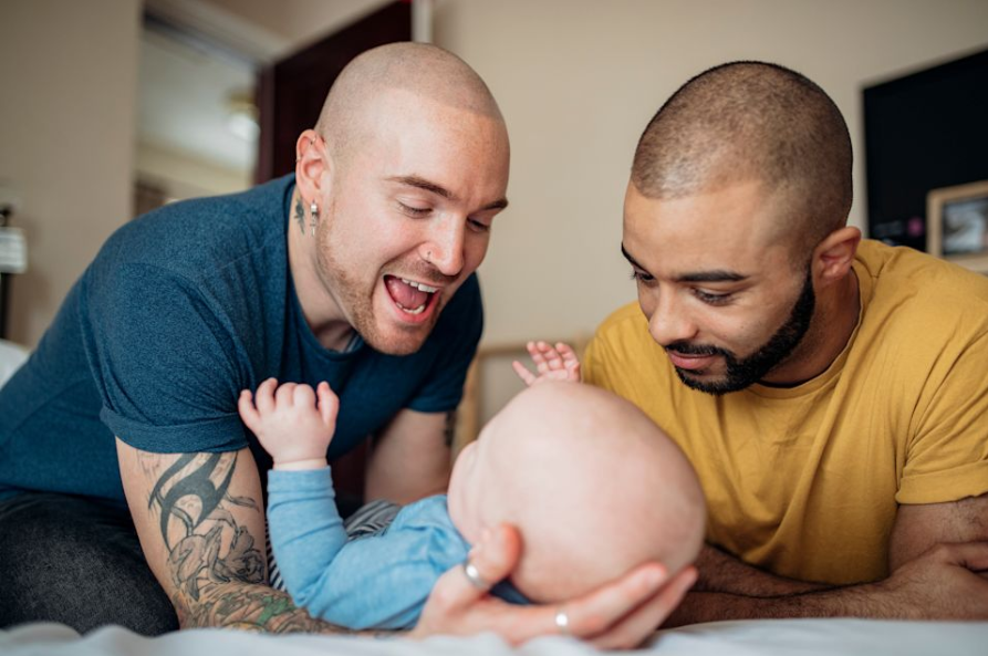 Two fathers with their baby
